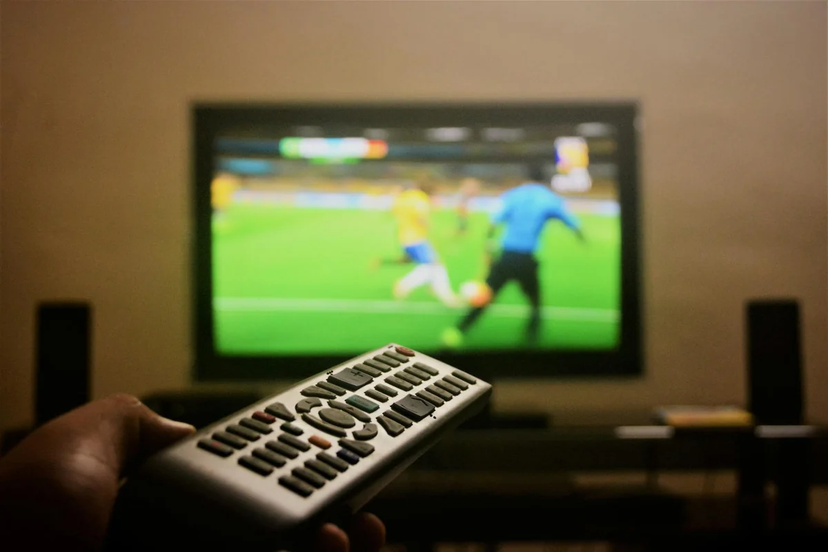 MAG set-top box connected to a television with remote control for IPTV streaming